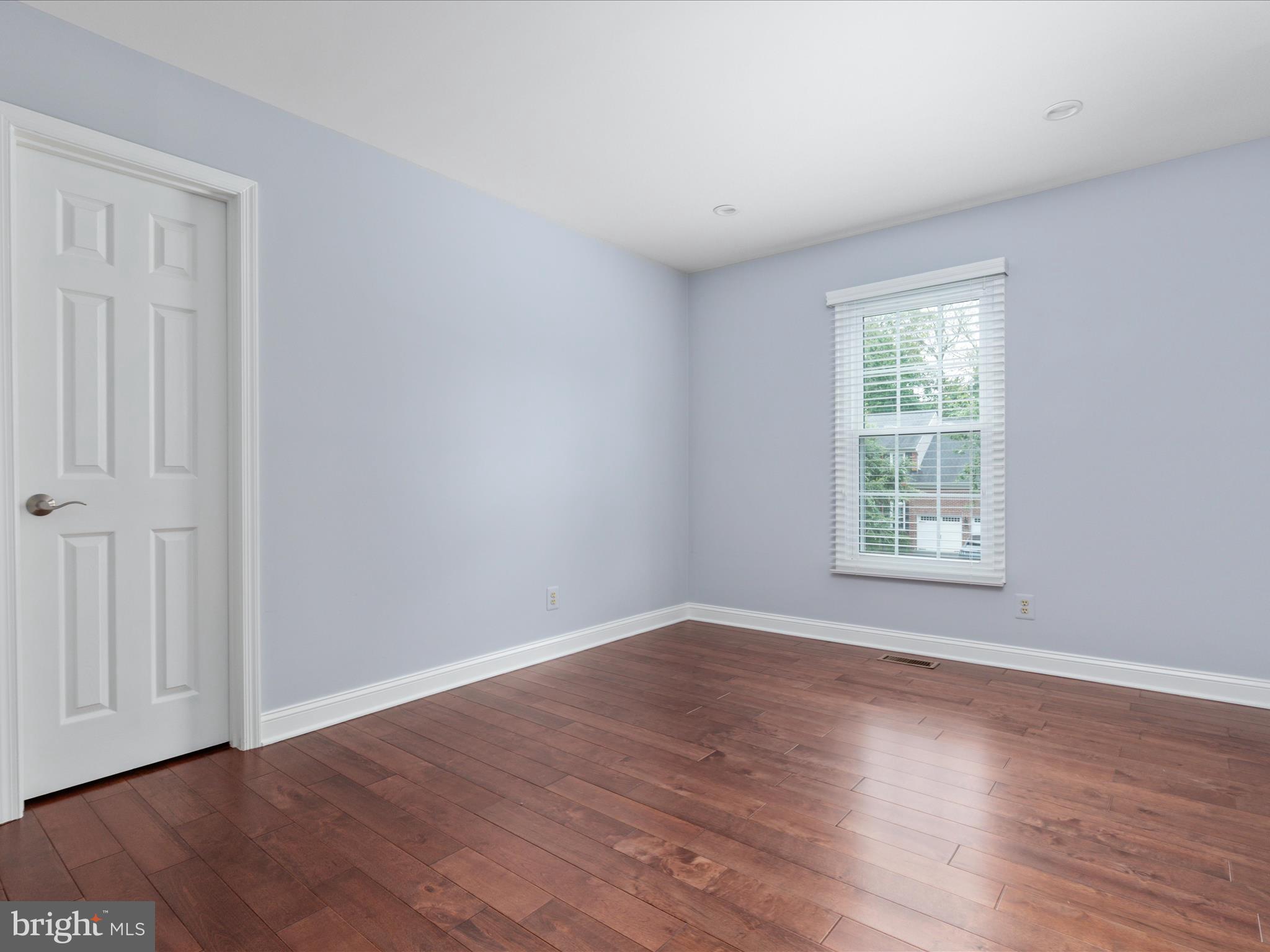 20462 Quarterpath Trace Circle Sterling, VA 20165 - Photo 33 of 58 a view of an empty room with wooden floor and a window