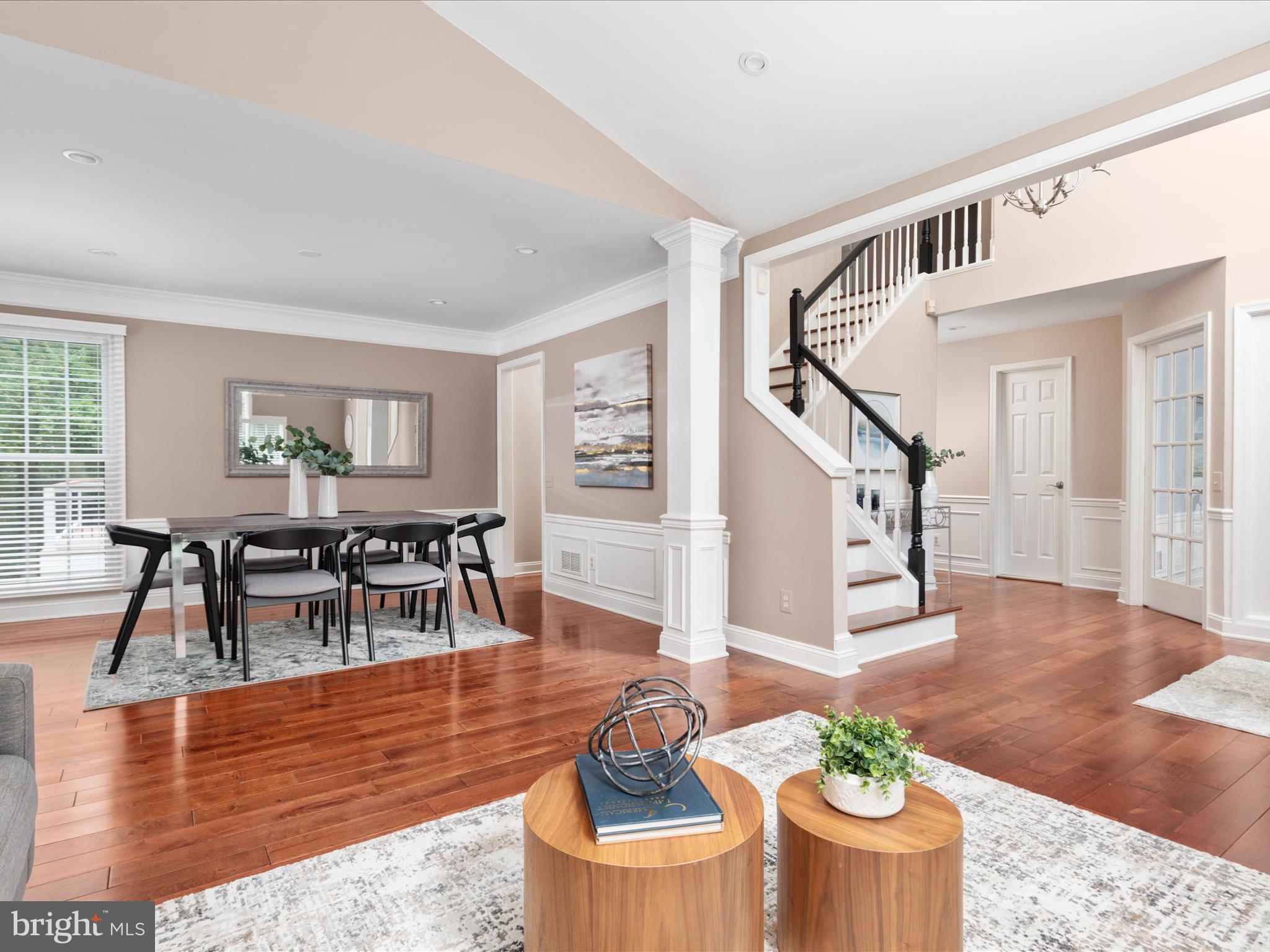 20462 Quarterpath Trace Circle Sterling, VA 20165 - Photo 8 of 58 a living room with furniture and a dining table with wooden floor
