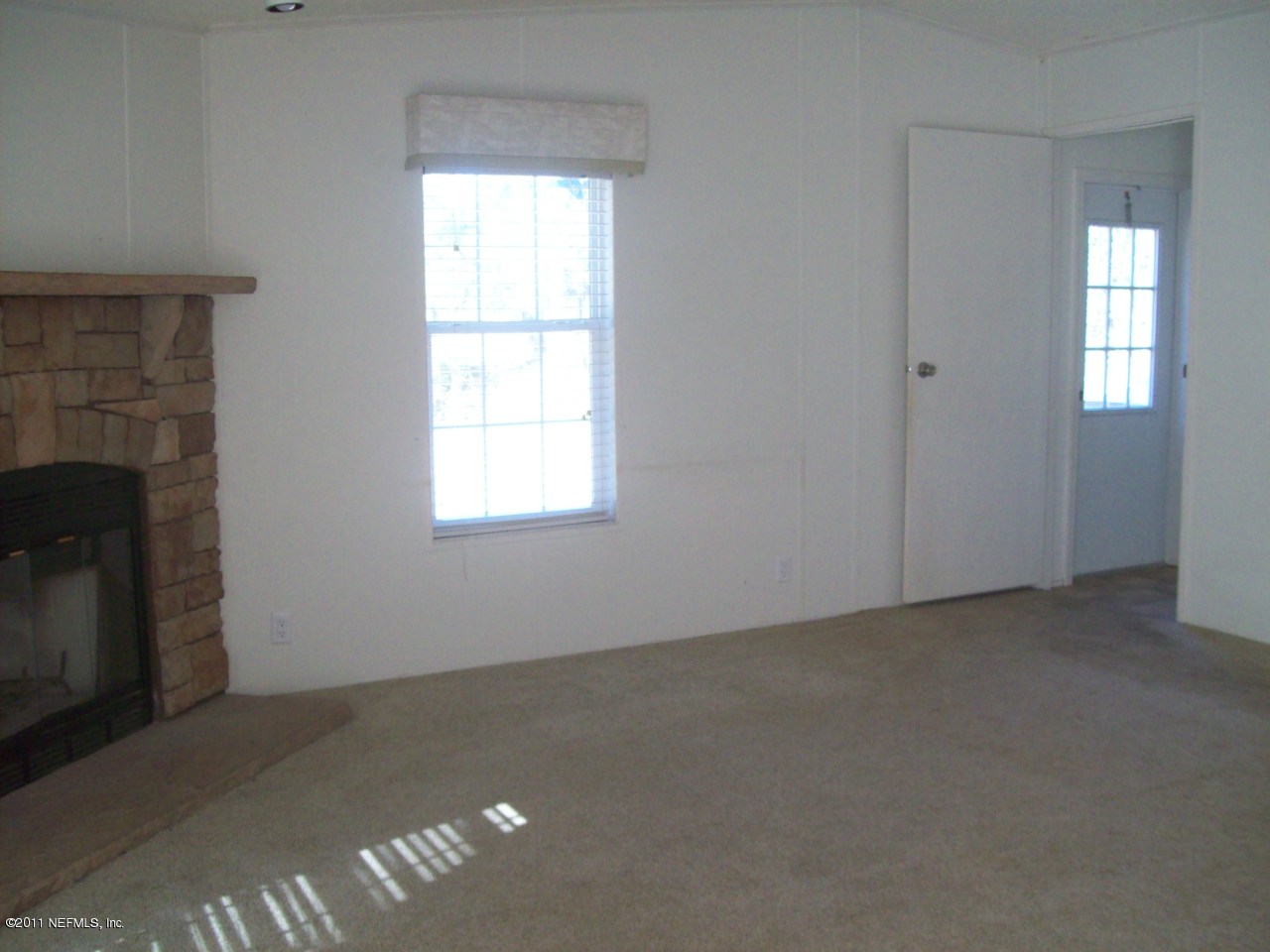45128 Zidell Road Callahan, FL 32011 - Photo 11 of 12 an empty room with a fireplace