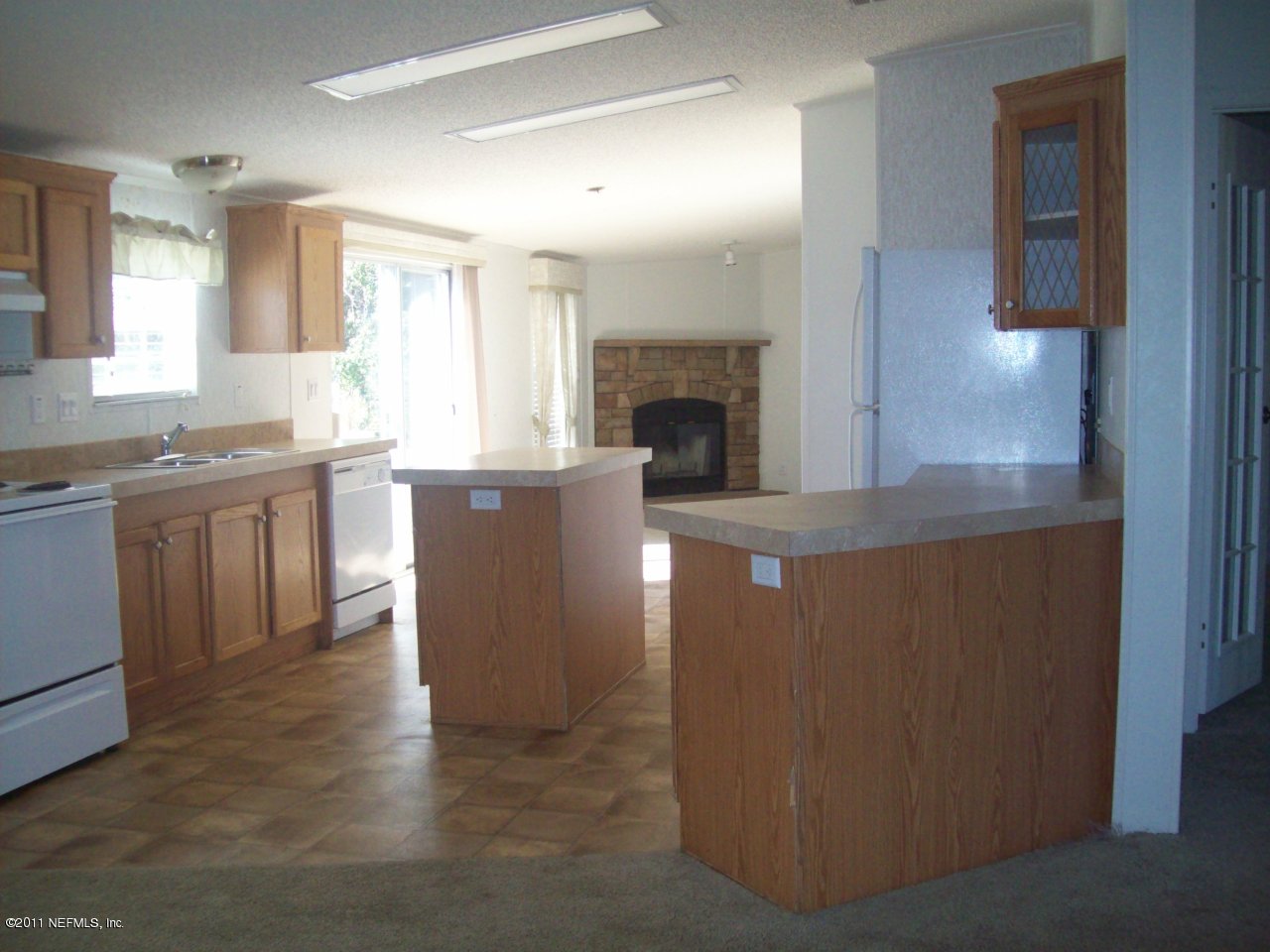 45128 Zidell Road Callahan, FL 32011 - Photo 12 of 12 a living room with stainless steel appliances granite countertop furniture and a fireplace