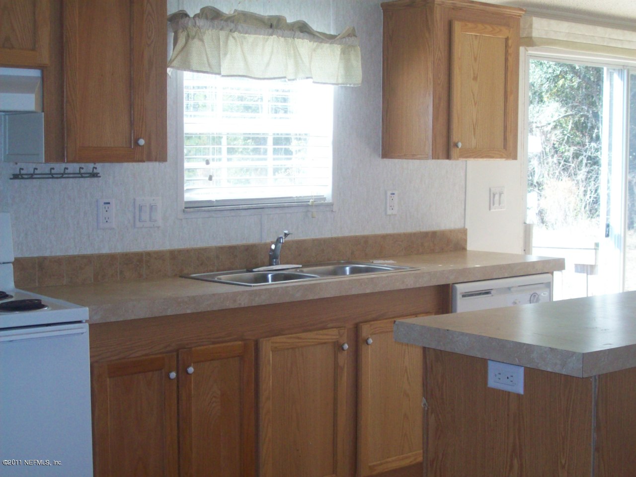 45128 Zidell Road Callahan, FL 32011 - Photo 3 of 12 a kitchen with a sink cabinets and a large window