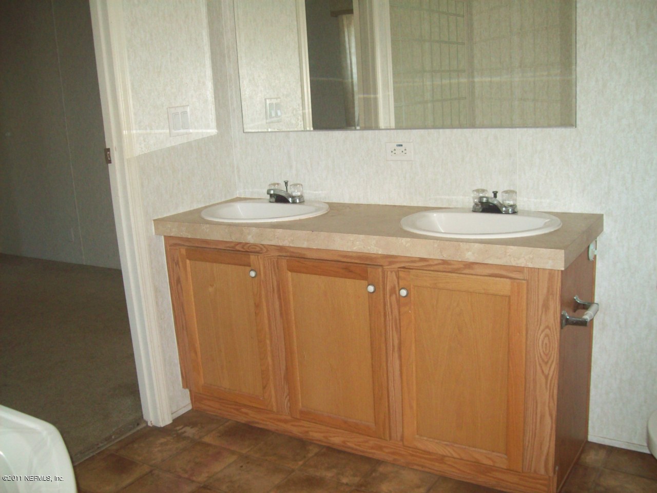 45128 Zidell Road Callahan, FL 32011 - Photo 10 of 12 a bathroom with a sink a toilet and a mirror