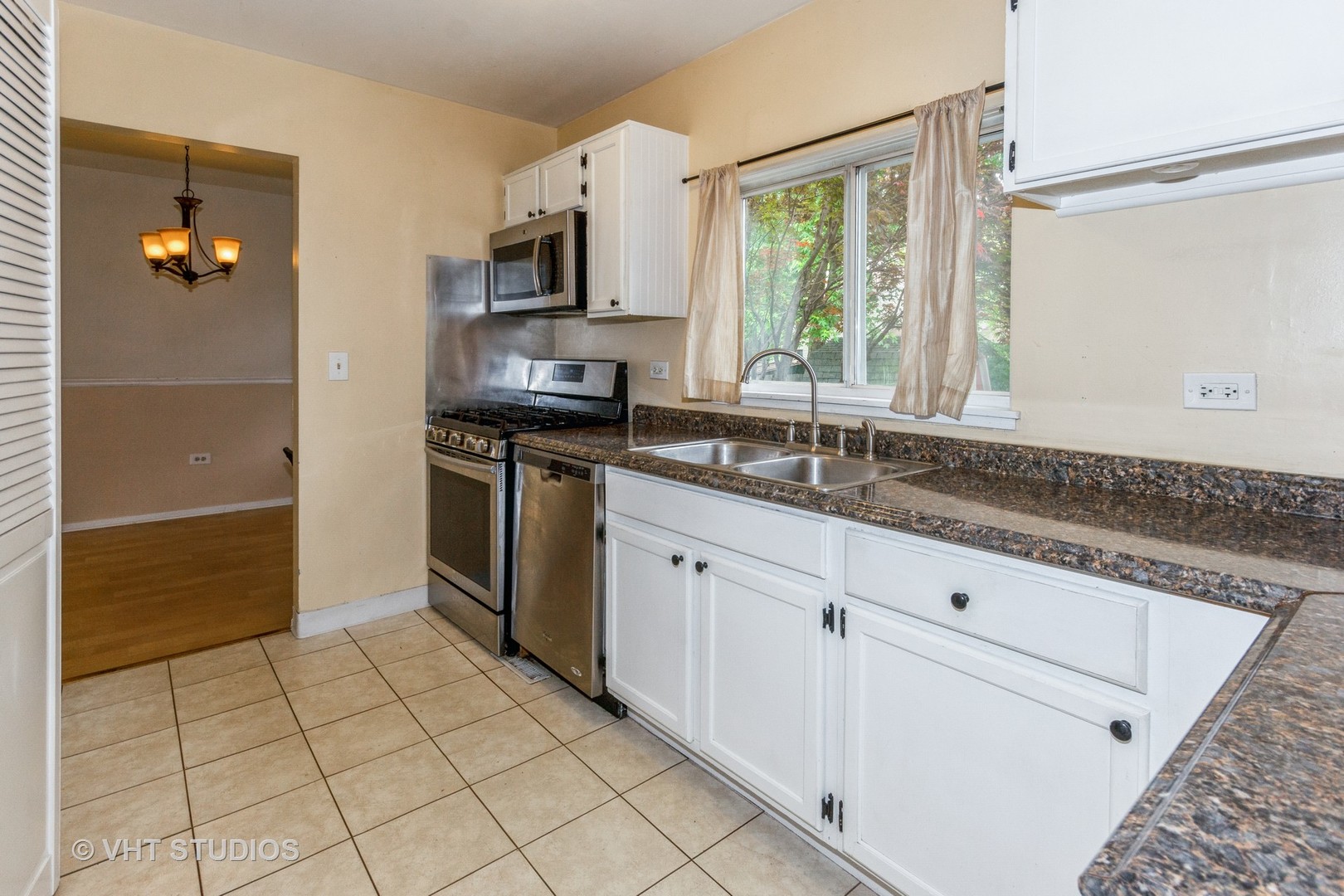 1216 Calico Avenue Naperville, IL 60564 - Photo 3 of 16 a kitchen with stainless steel appliances granite countertop a sink and a stove
