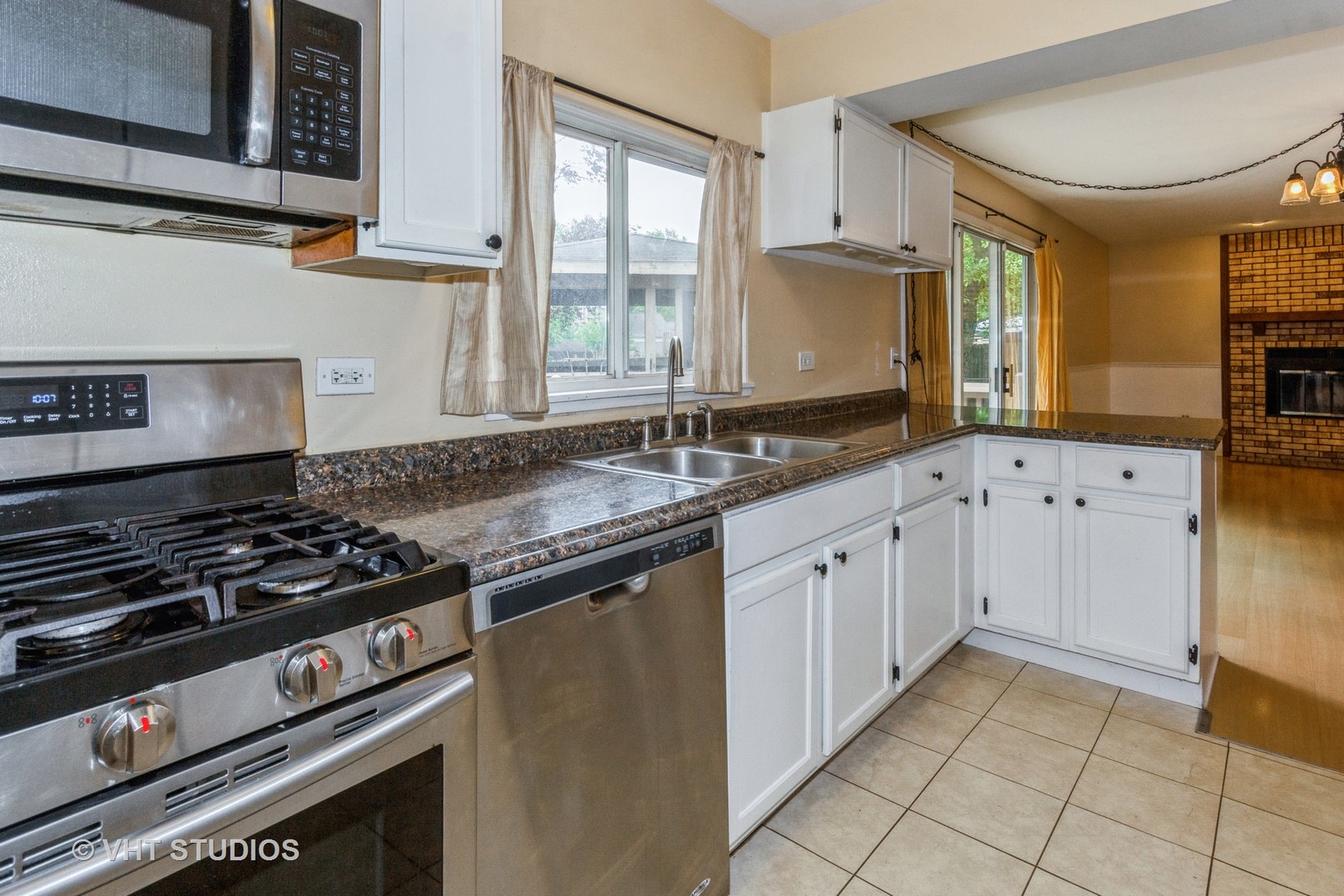 1216 Calico Avenue Naperville, IL 60564 - Photo 4 of 16 a kitchen with granite countertop a stove sink and cabinets