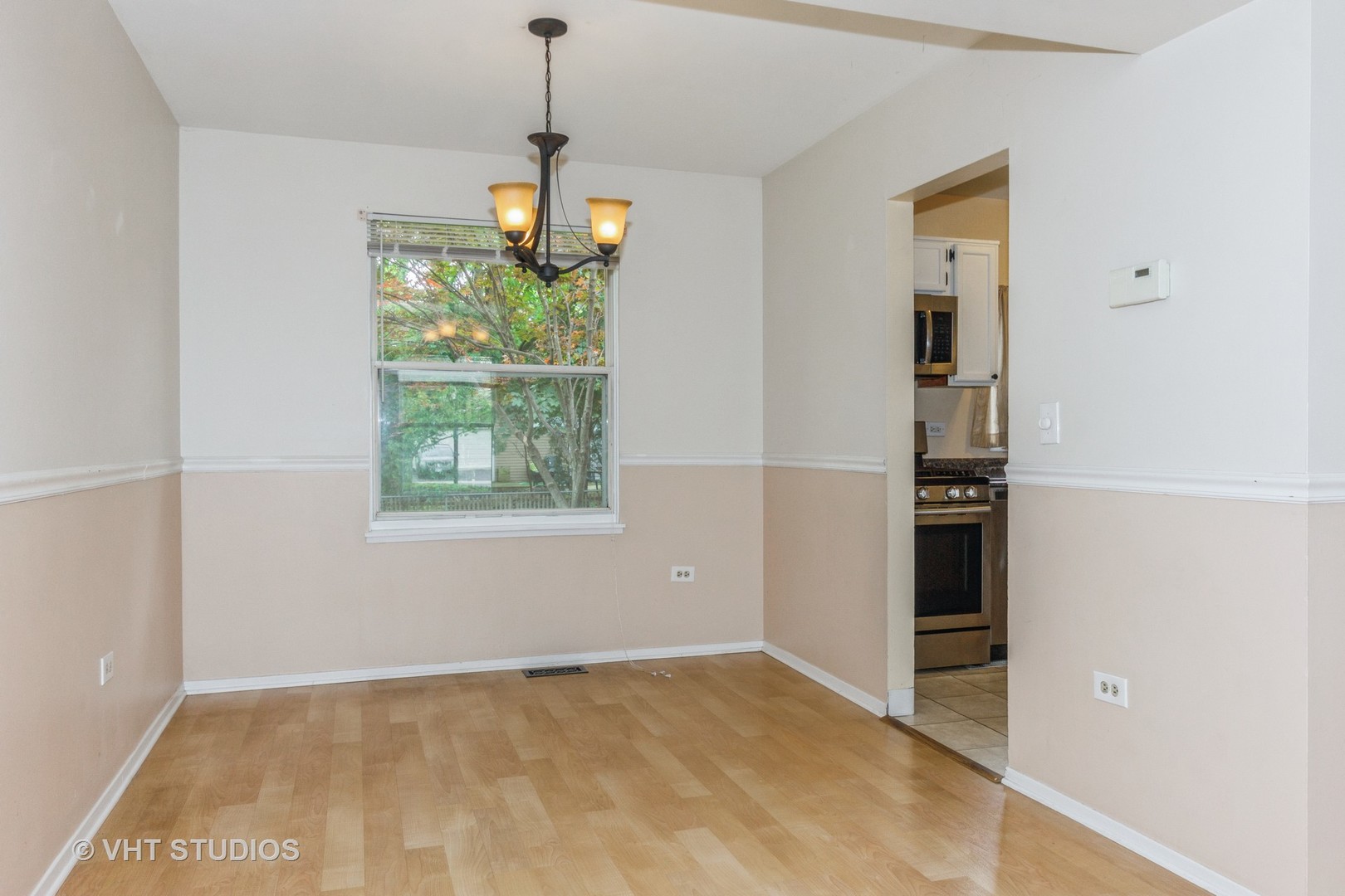 1216 Calico Avenue Naperville, IL 60564 - Photo 5 of 16 a view of an empty room with a window