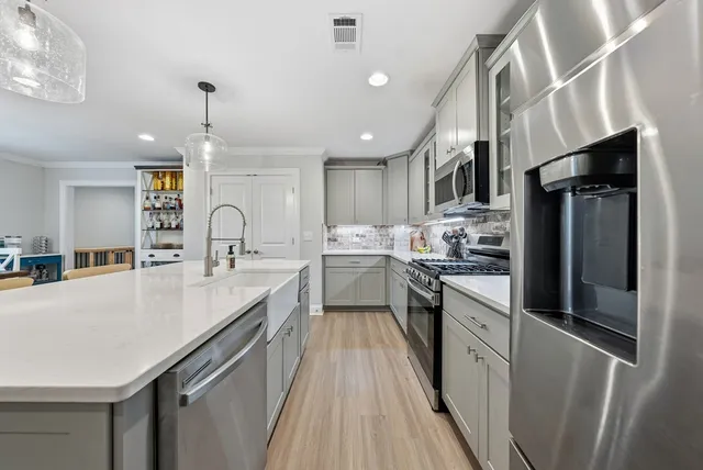 a kitchen with a sink stove and refrigerator