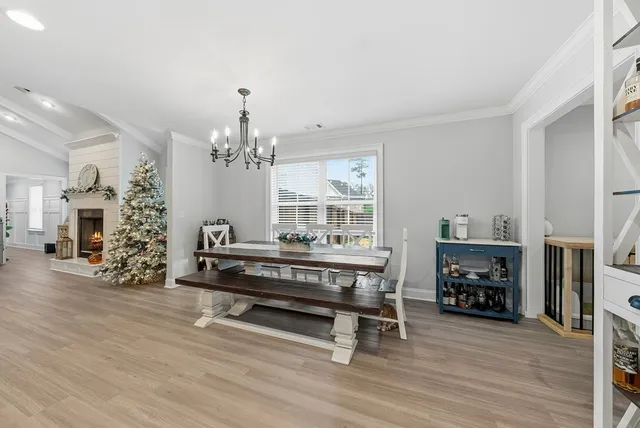 a large white kitchen with a sink and refrigerator