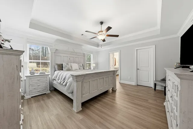 a view of a hallway with wooden floor and entryway