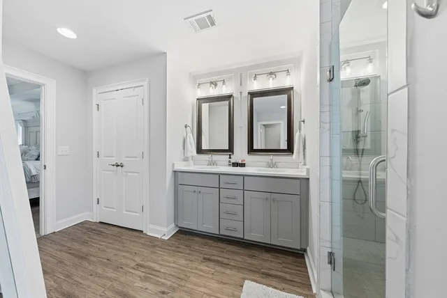 a spacious bathroom with a mirror and a shower
