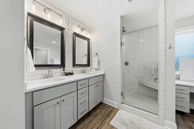 a bathroom with a double vanity sink mirror and double