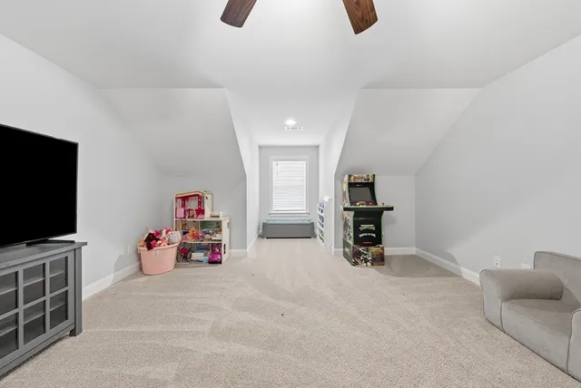 a children room with furniture and a flat screen tv