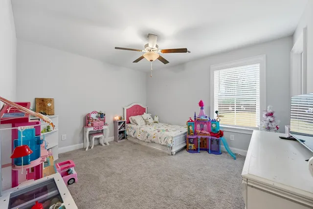 a bedroom with furniture and a window