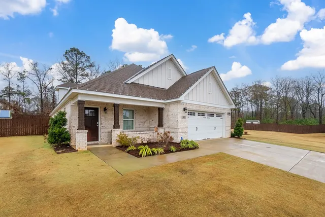 a front view of a house with a yard and a garage