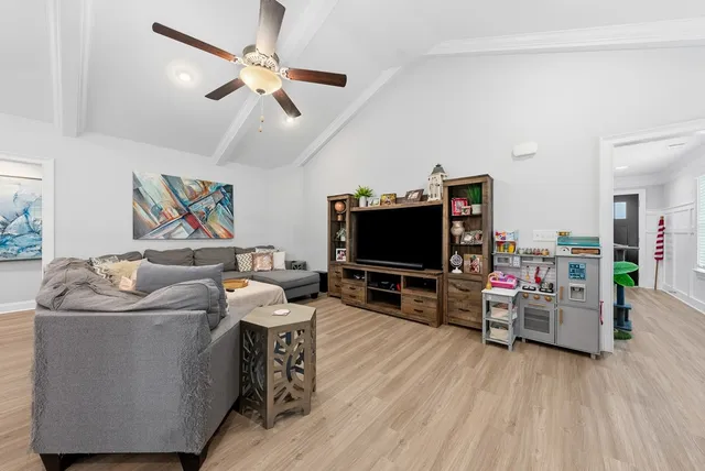 a living room with furniture and flowers