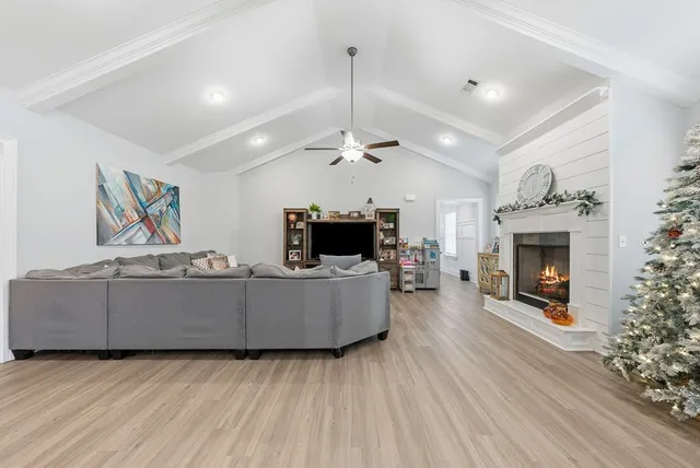 a living room with furniture and a flat screen tv