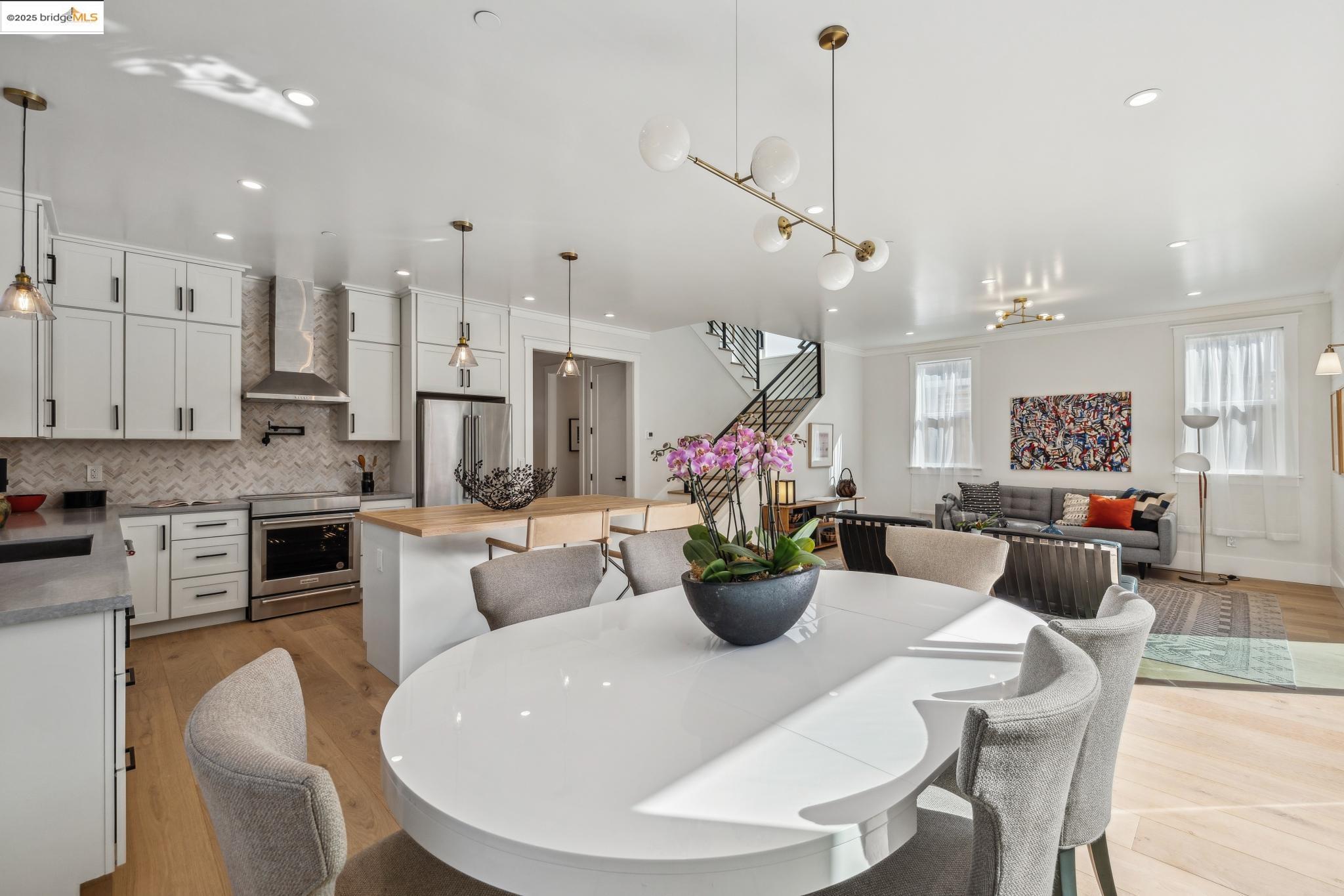2310 Eighth Street Berkeley, CA 94710 - Photo 13 of 44 a view of a dining room and livingroom with furniture wooden floor a chandelier