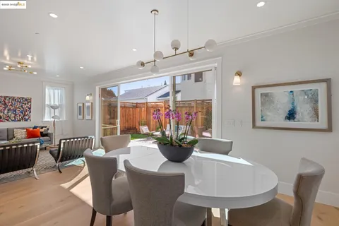 a dining room with furniture and wooden floor