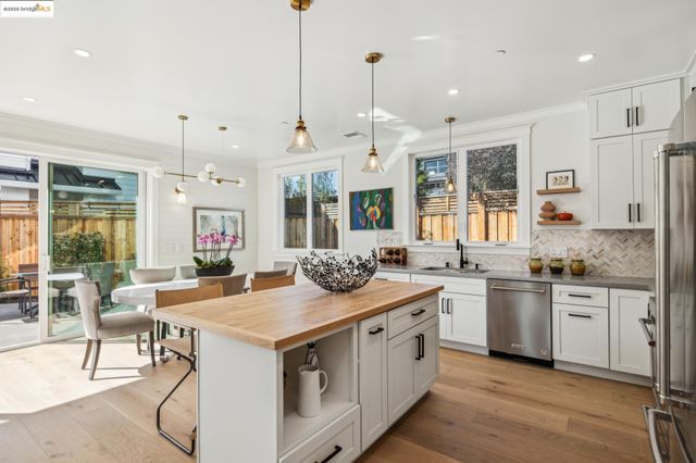 a kitchen with stainless steel appliances granite countertop a stove and a wooden floors