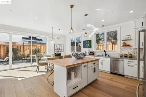 a large kitchen with stainless steel appliances granite countertop a stove and cabinets