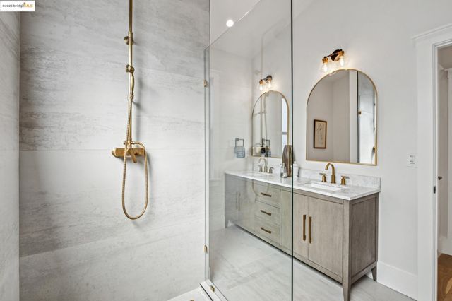 a bathroom with a shower sink and mirror