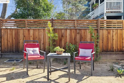 a wooden bench sitting in backside of a house