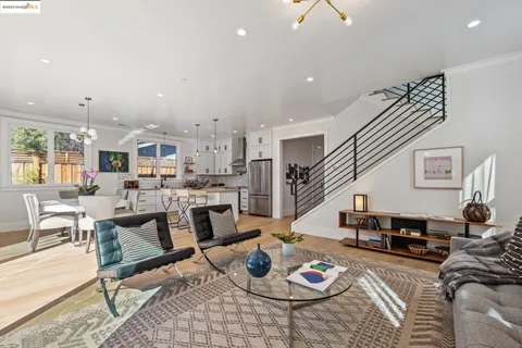 a living room with furniture kitchen view and a table