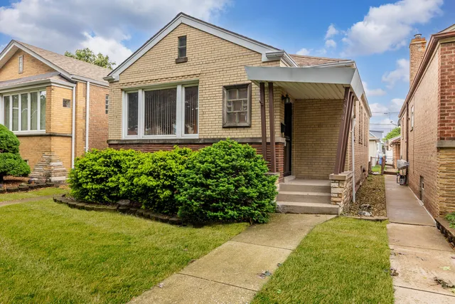 a front view of a house with a garden