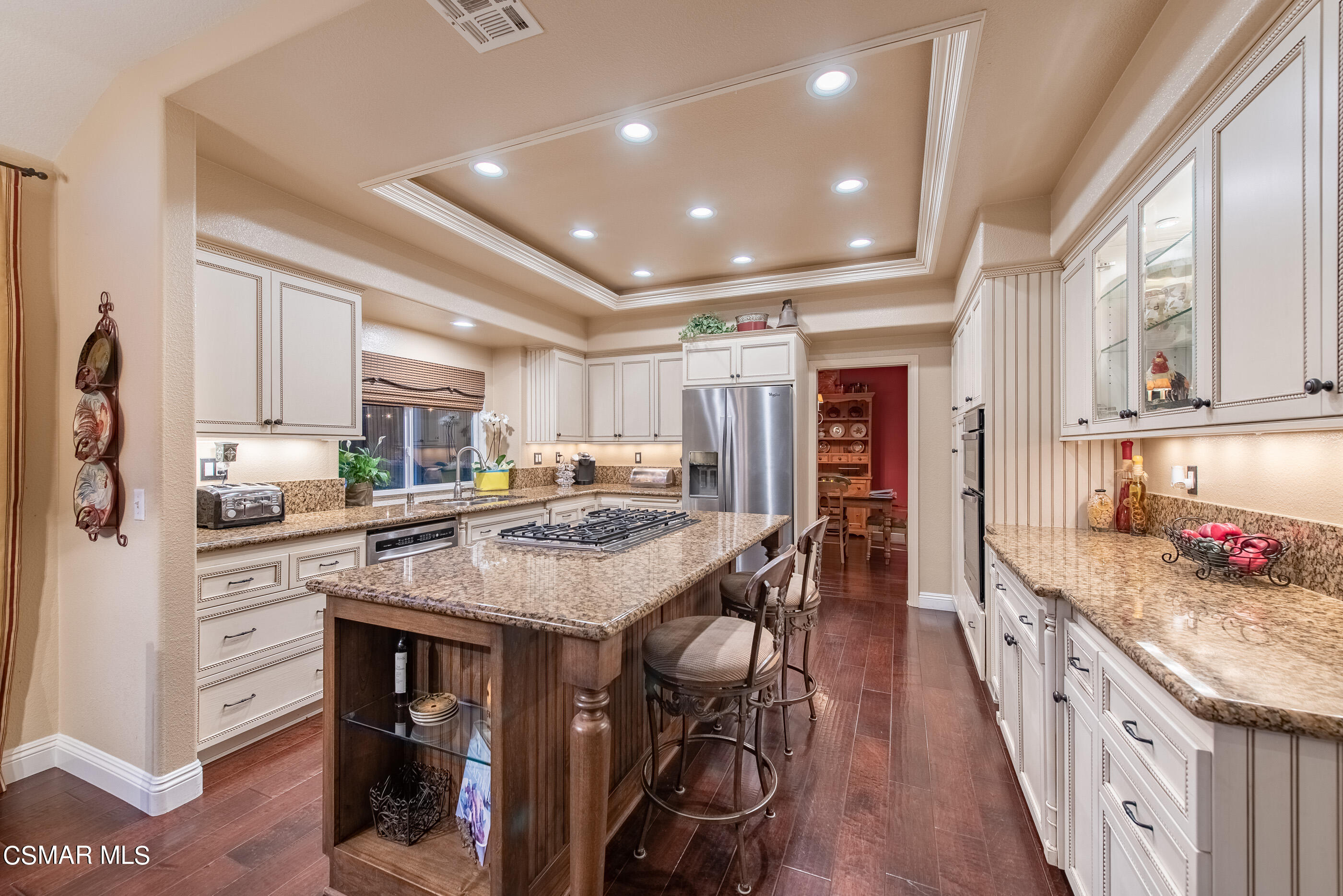 116 Valley Gate Road Simi Valley, CA 93065 - Photo 16 of 59 a kitchen with stainless steel appliances kitchen island granite countertop a table chairs stove and cabinets