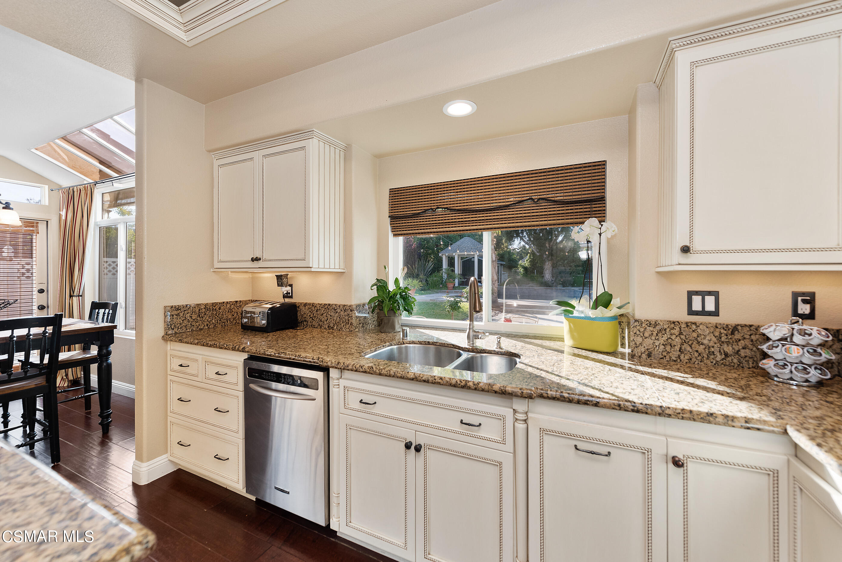 116 Valley Gate Road Simi Valley, CA 93065 - Photo 17 of 59 a kitchen with granite countertop a sink a stove a dining table and chairs