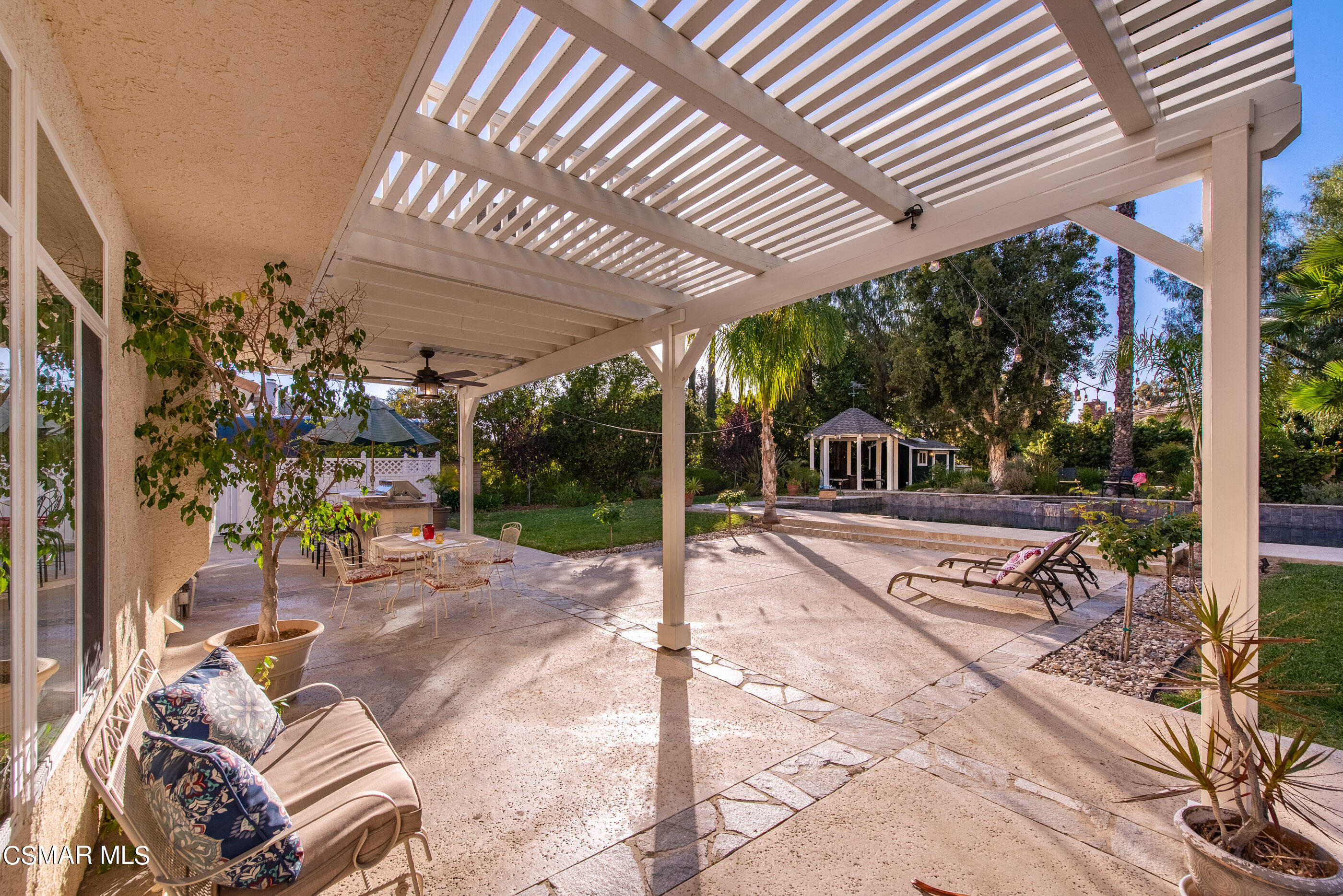 116 Valley Gate Road Simi Valley, CA 93065 - Photo 34 of 59 a view of a patio with a table and chairs under an umbrella