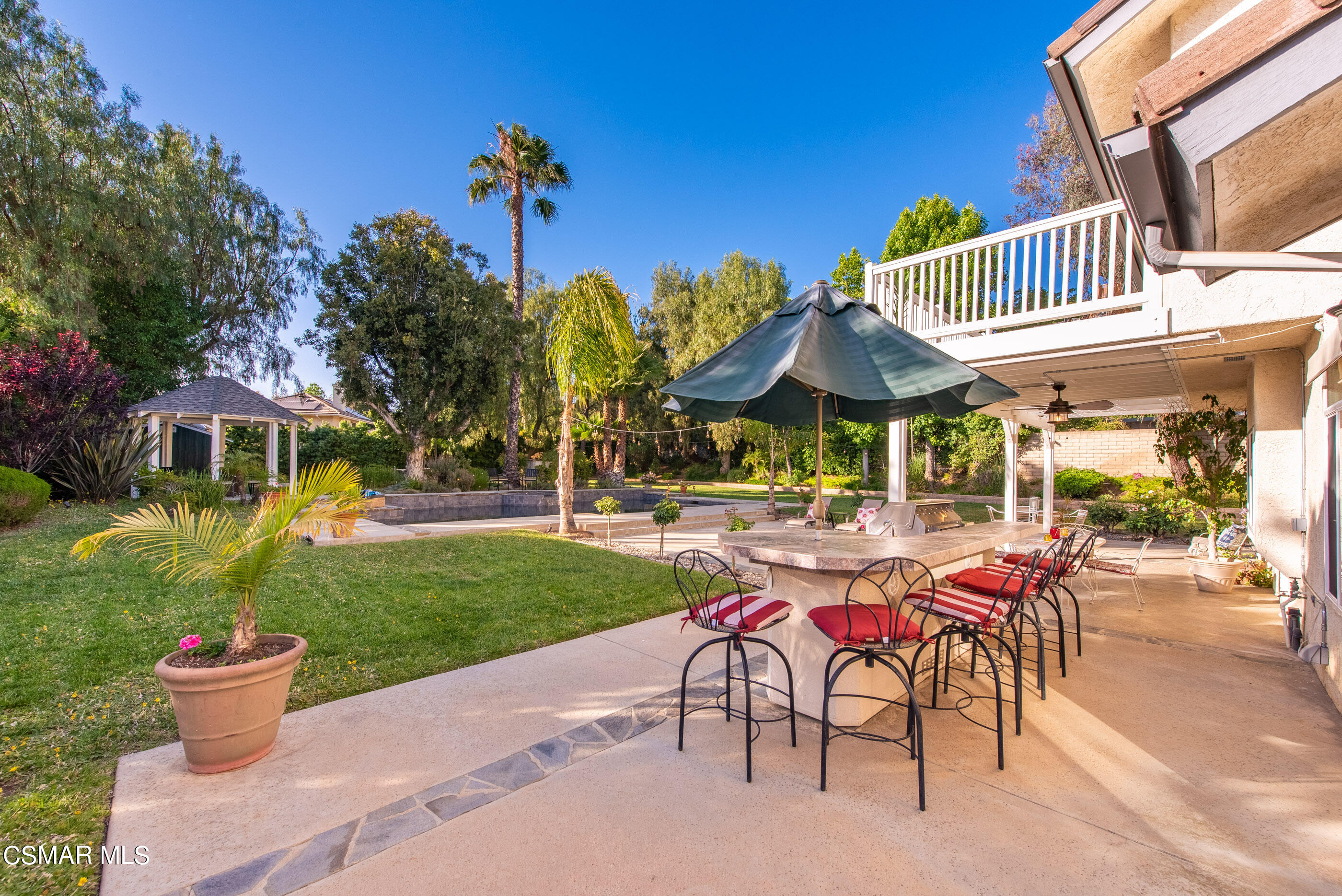 116 Valley Gate Road Simi Valley, CA 93065 - Photo 35 of 59 a view of a patio with a table and chairs under an umbrella