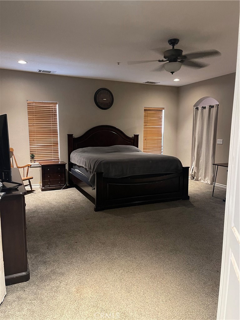 7677 Mono Road Phelan, CA 92371 - Photo 11 of 16 a bedroom with a bed and a ceiling fan
