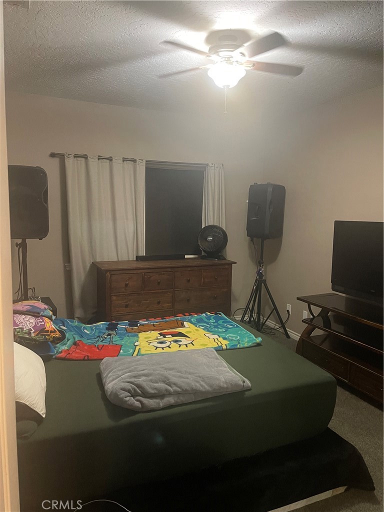 7677 Mono Road Phelan, CA 92371 - Photo 12 of 16 a bedroom with a bed and a lamp on the dresser