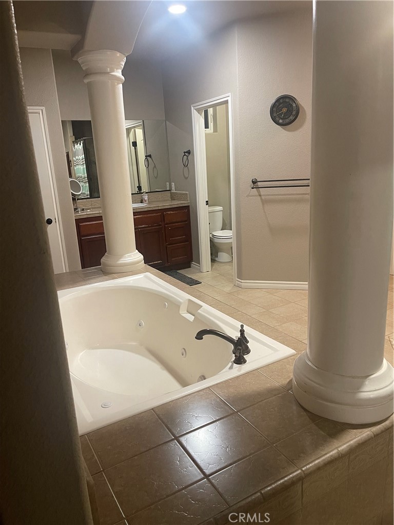 7677 Mono Road Phelan, CA 92371 - Photo 14 of 16 a bathroom with a tub sink and mirror