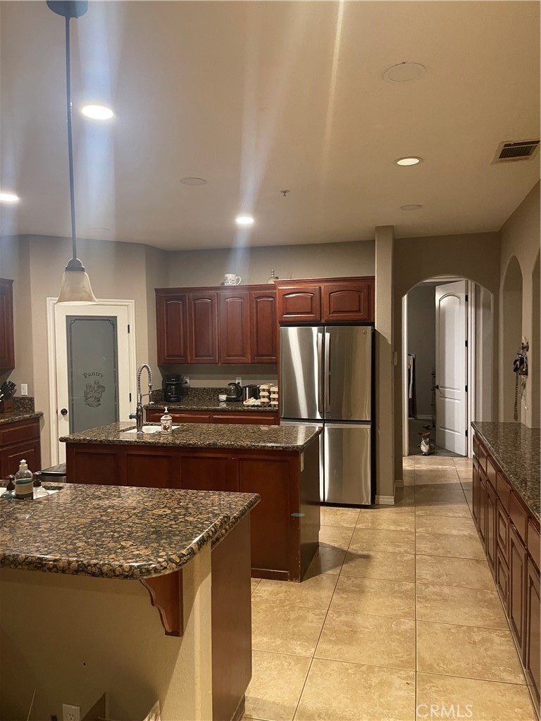 7677 Mono Road Phelan, CA 92371 - Photo 3 of 16 a kitchen with stainless steel appliances granite countertop a refrigerator and a sink