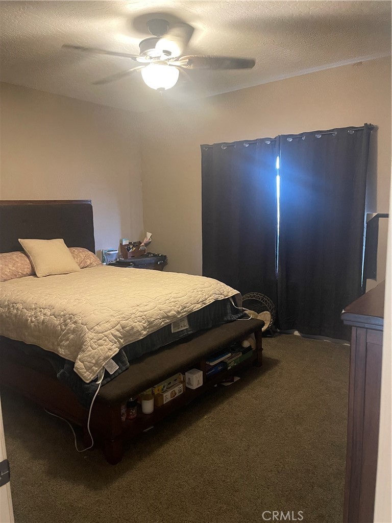 7677 Mono Road Phelan, CA 92371 - Photo 7 of 16 a bedroom with a bed and a night stand