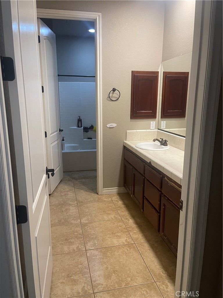 7677 Mono Road Phelan, CA 92371 - Photo 8 of 16 a bathroom with a sink a toilet and mirror