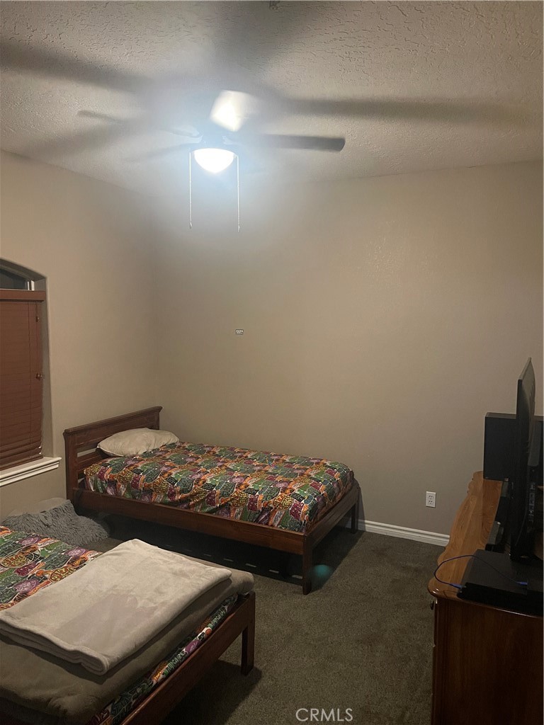 7677 Mono Road Phelan, CA 92371 - Photo 9 of 16 a bedroom with a bed and furniture