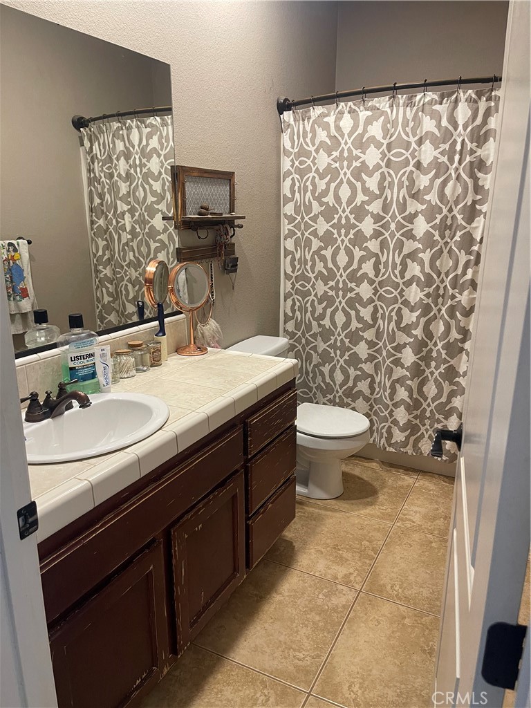 7677 Mono Road Phelan, CA 92371 - Photo 10 of 16 a bathroom with a sink toilet and mirror