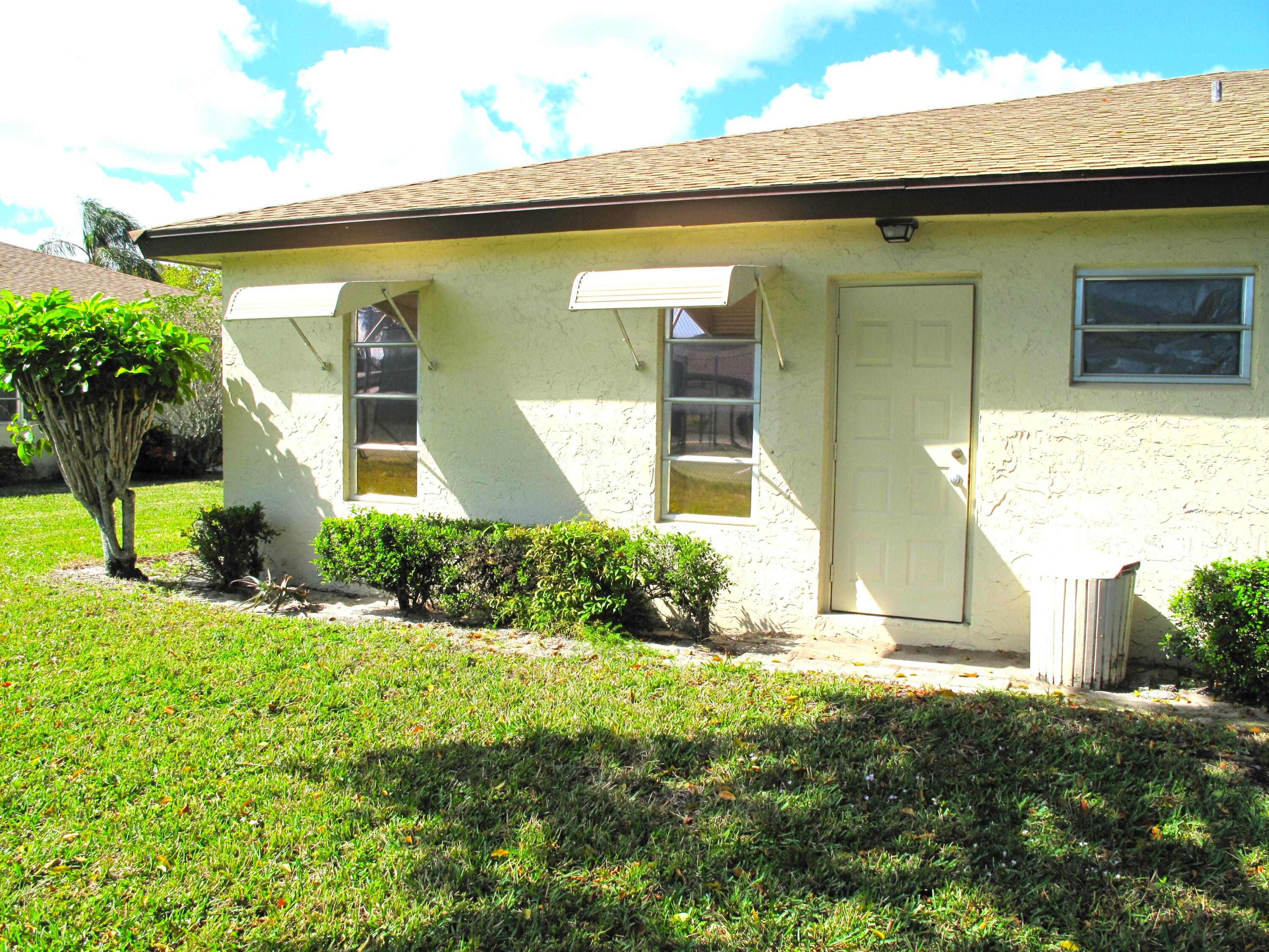 5220 Nesting Way, Unit D Delray Beach, FL 33484 - Photo 23 of 40 rear view of villa