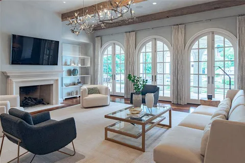 a living room with furniture fireplace and flat screen tv