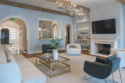 a living room with furniture fireplace and flat screen tv