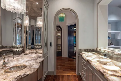 a bathroom with a granite countertop sink a mirror and vanity