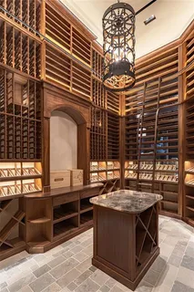 a living room with a window and a dresser