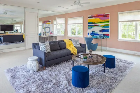 a view of pool with lawn chairs and couches