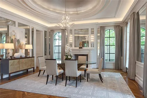 a view of a dining room with furniture wooden floor and chandelier