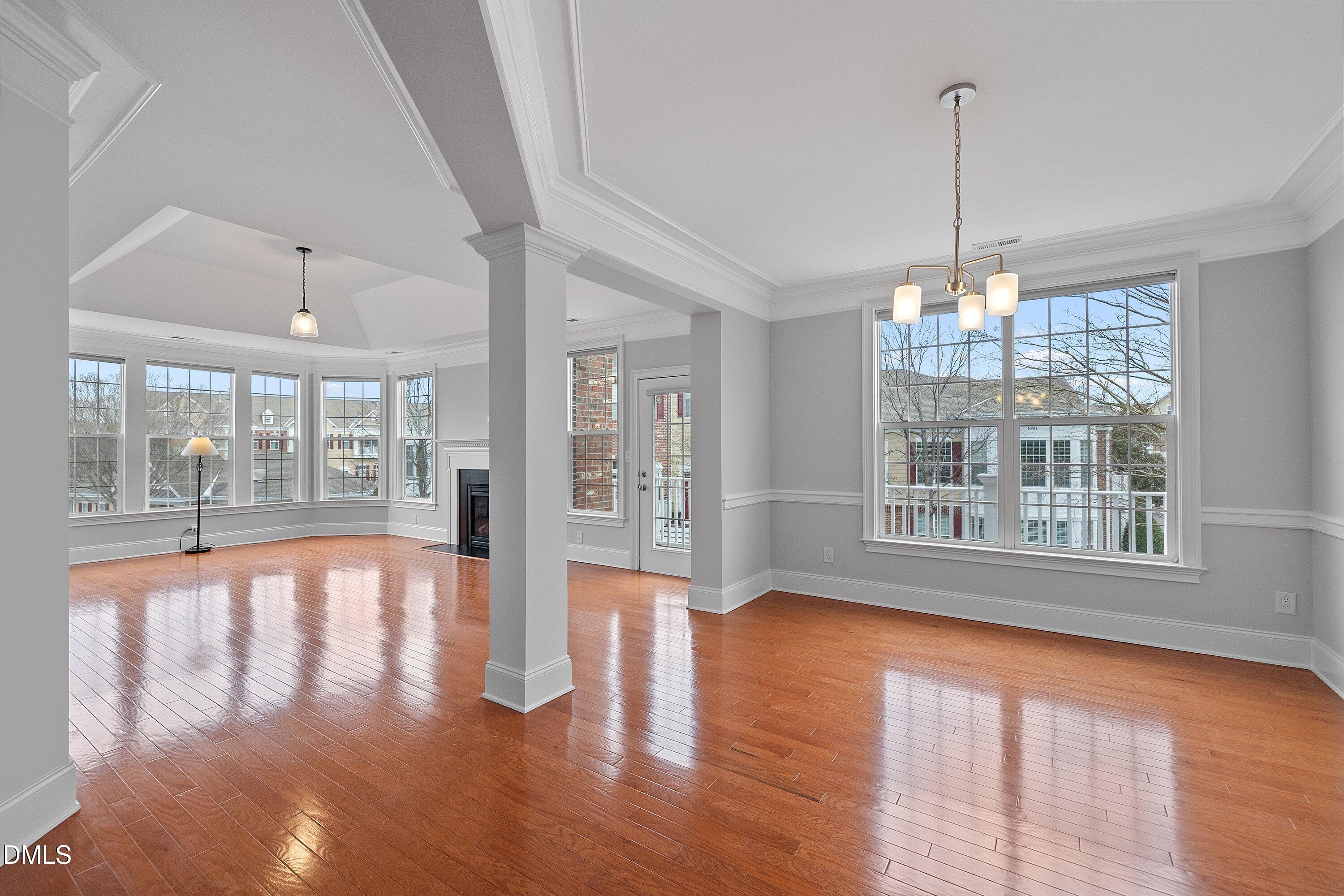 9211 Calabria Drive, Unit 205 Raleigh, NC 27617 - Photo 5 of 55 a view of an empty room with wooden floor and a window