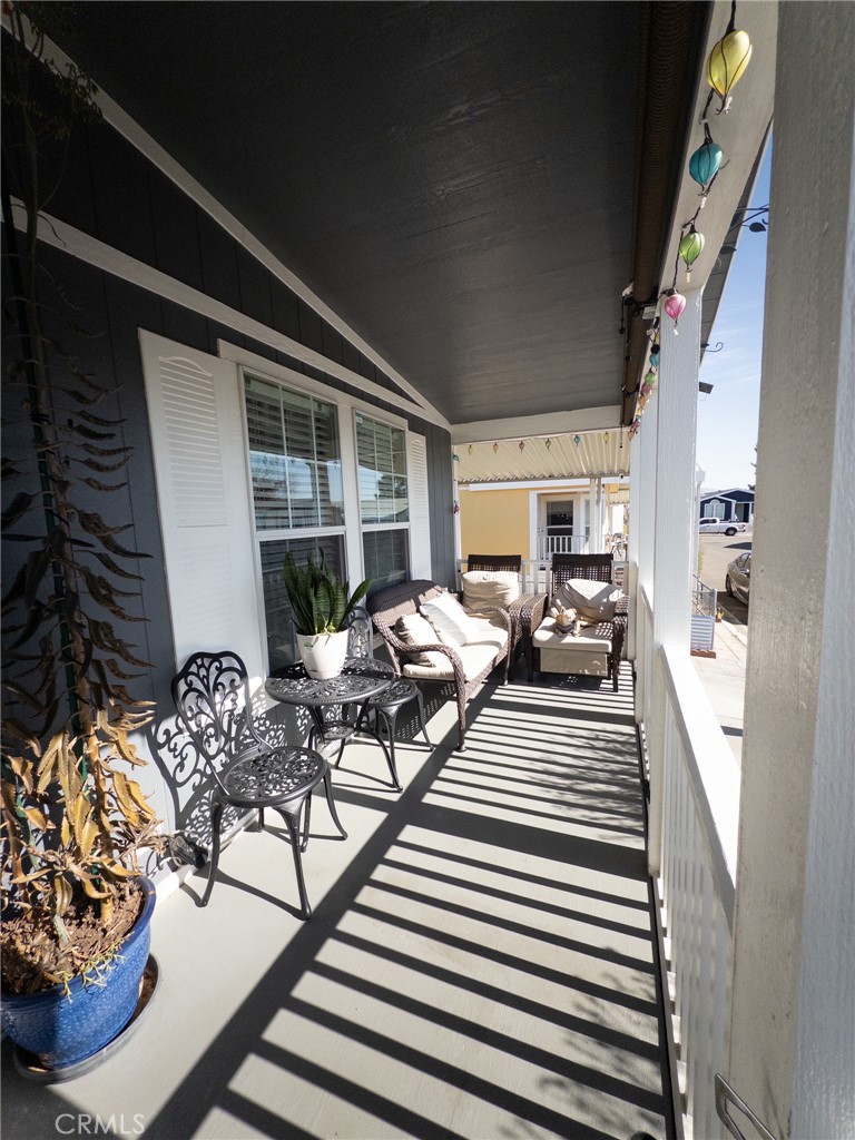 20843 Waalew Road Apple Valley, CA 92307 - Photo 15 of 32 a view of balcony with chairs and potted plant
