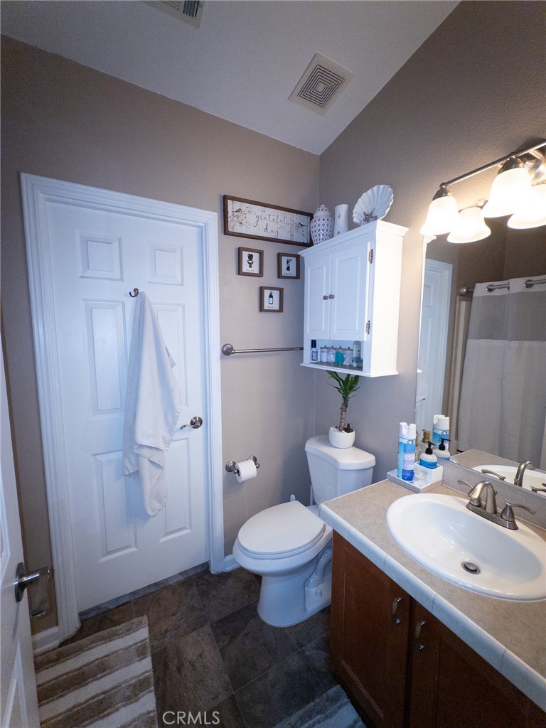 20843 Waalew Road Apple Valley, CA 92307 - Photo 22 of 32 a bathroom with a sink a toilet and shower