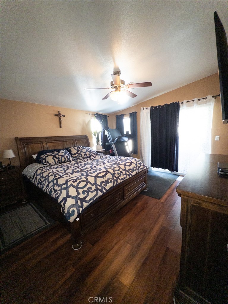 20843 Waalew Road Apple Valley, CA 92307 - Photo 25 of 32 a bedroom with a bed mirror and a window